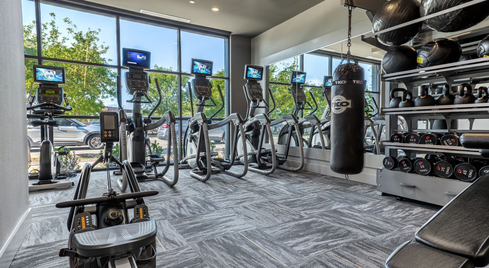 a gym room with exercise equipment and mirrors at The Ramble and Rose