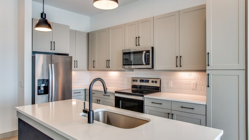 a kitchen with stainless steel appliances and white counter tops at The Ramble and Rose