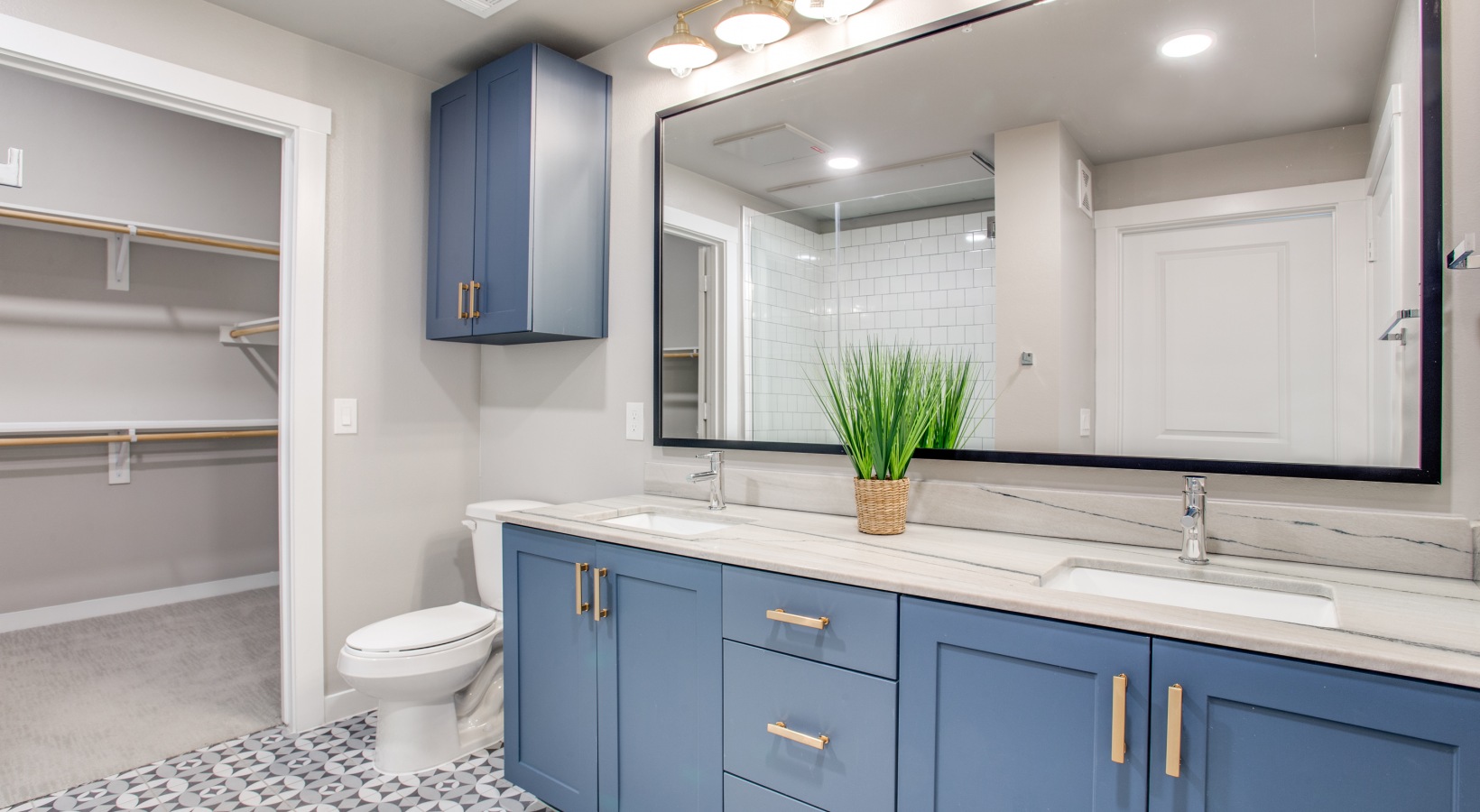 a bathroom with blue cabinets and a toilet at The Ramble and Rose