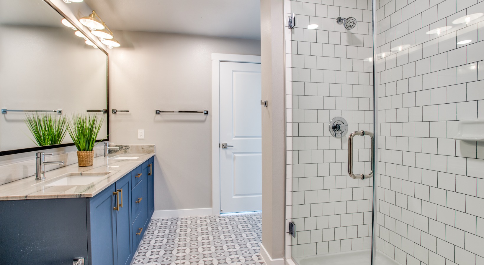 a bathroom with blue cabinets and a shower stall at The Ramble and Rose
