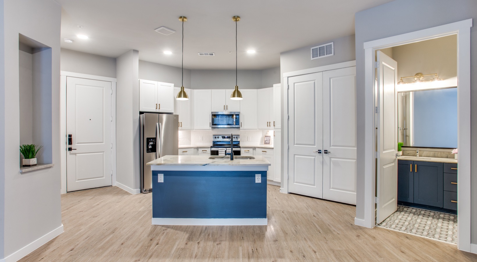 a kitchen with blue cabinets and white appliances at The Ramble and Rose