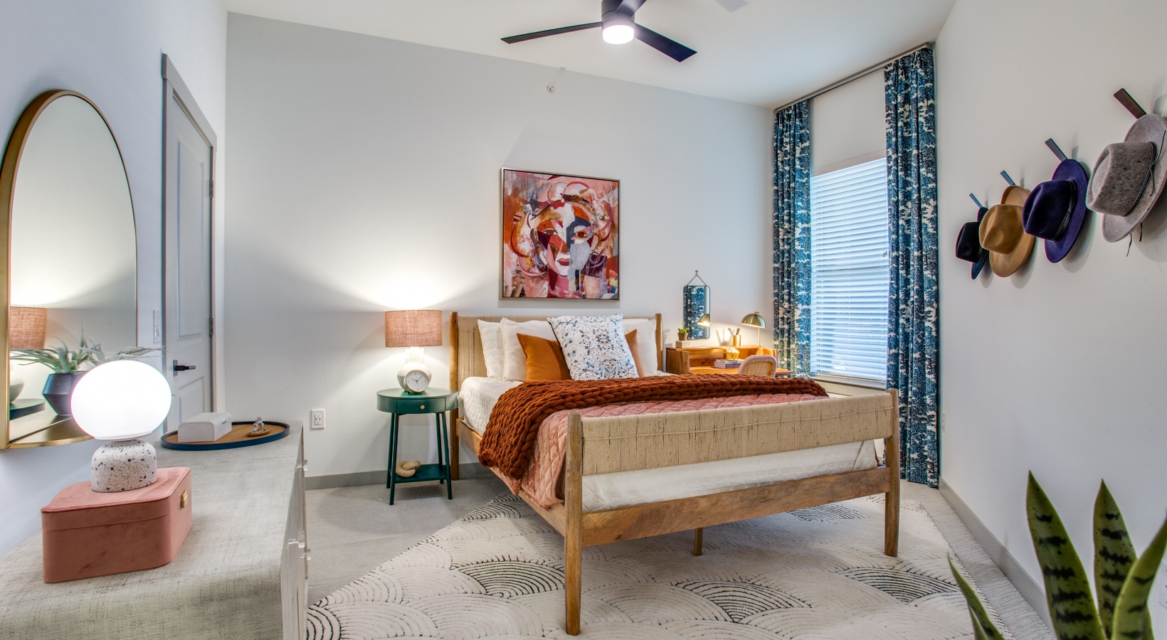 a bedroom with a bed, dresser and a ceiling fan at The Ramble and Rose