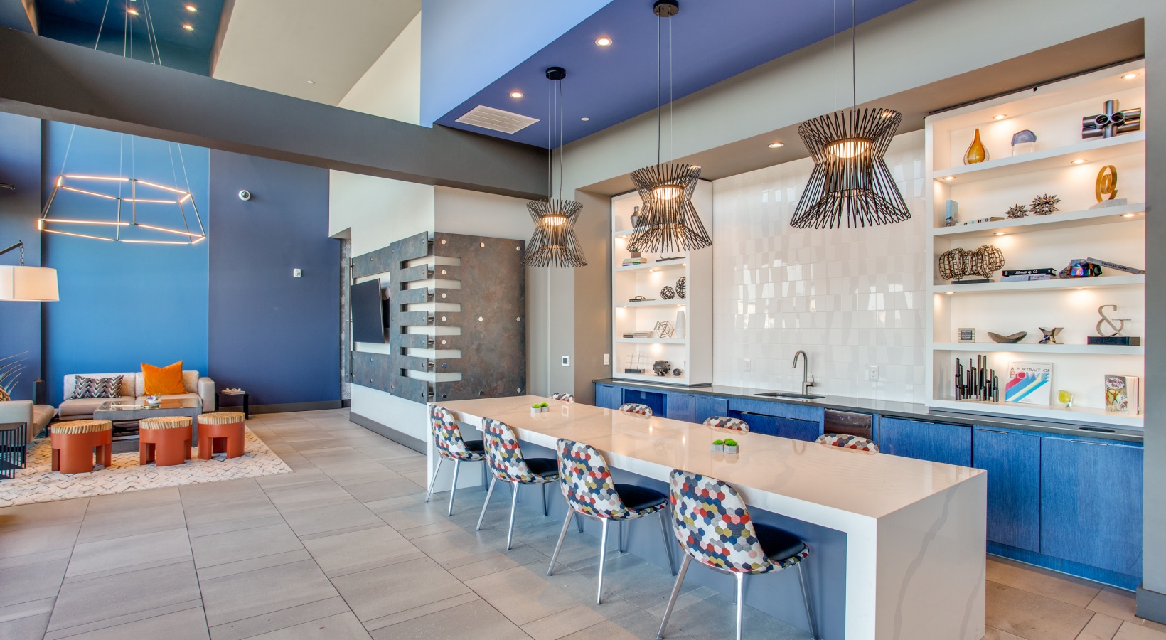 a modern kitchen with blue walls and white counter tops at The Ramble and Rose
