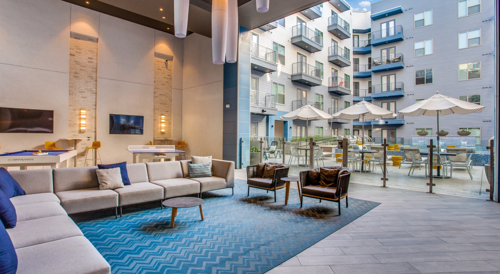 the lobby of an apartment building with blue carpeting at The Ramble and Rose