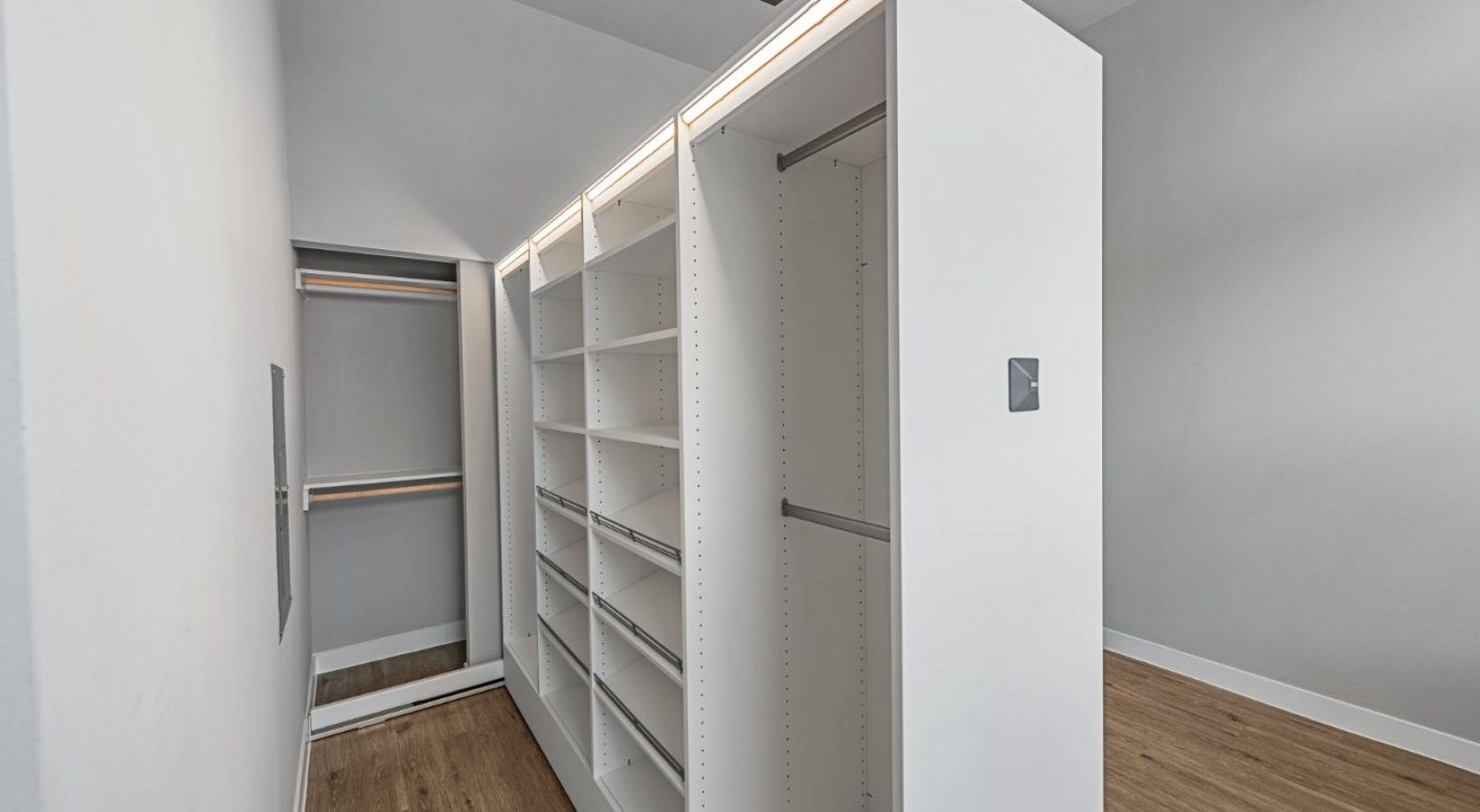 a walk in closet with shelves and a mirror at The Ramble and Rose