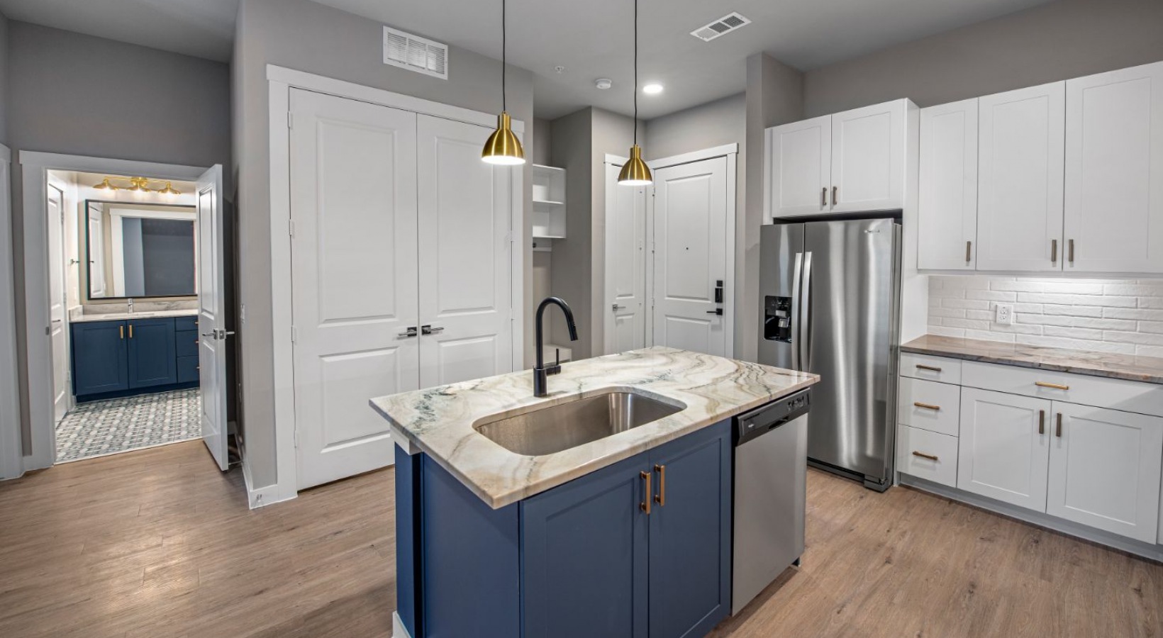 a kitchen with blue cabinets and stainless steel appliances at The Ramble and Rose