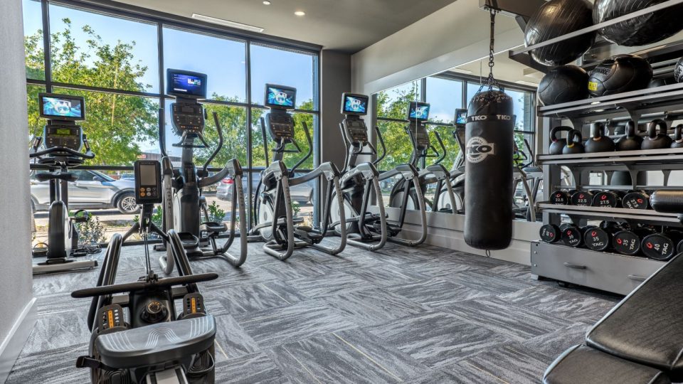 a gym room with exercise equipment and mirrors at The Ramble and Rose