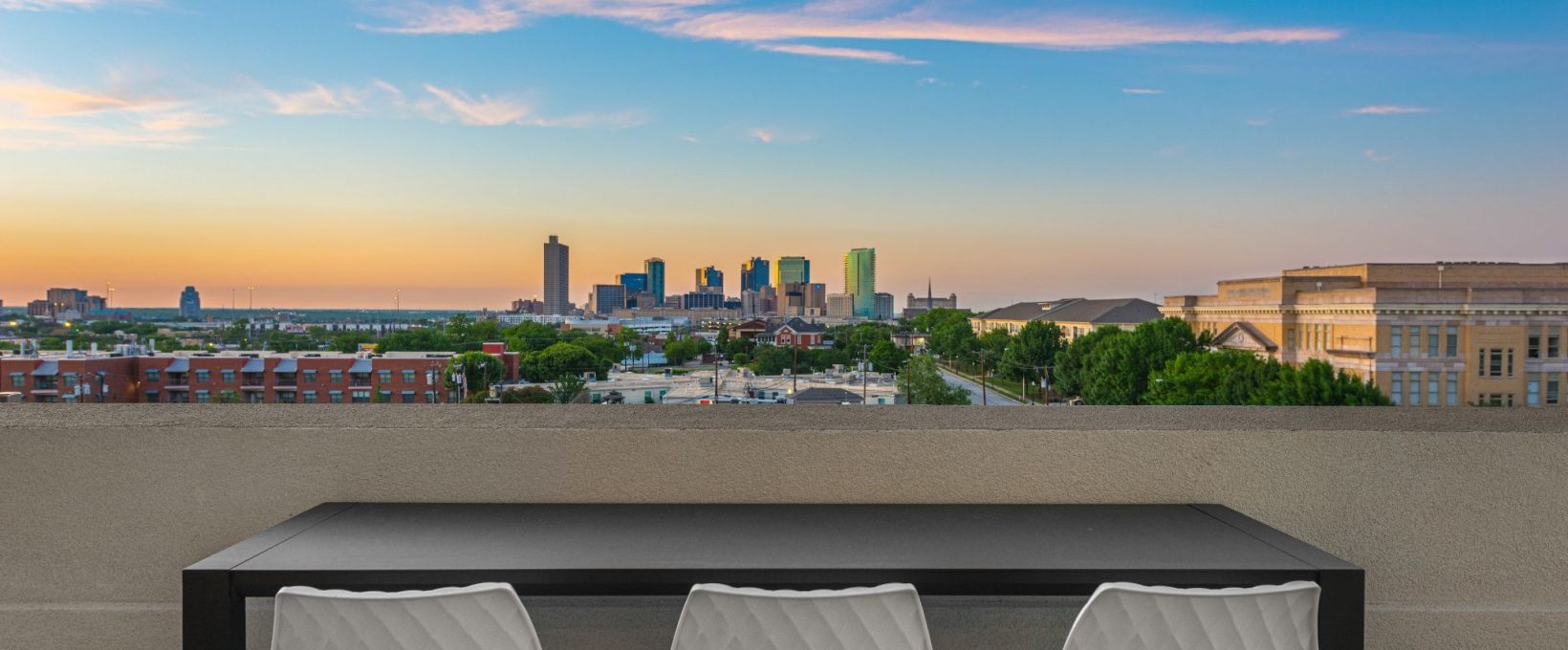 a table and chairs on a balcony overlooking a city at The Ramble and Rose