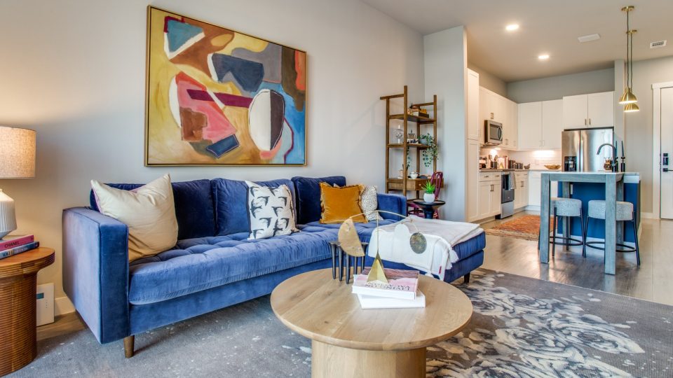 a living room with blue couch, blue chairs and a blue painting at The Ramble and Rose